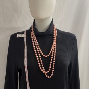 Two separate strands of vintage pink and brass bead necklaces from the 50’s.
